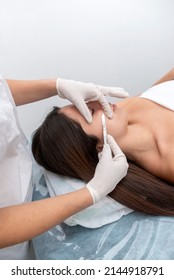 young woman in a beauty center performing a beauty treatment for the skin of the face with the dermaplaning technique