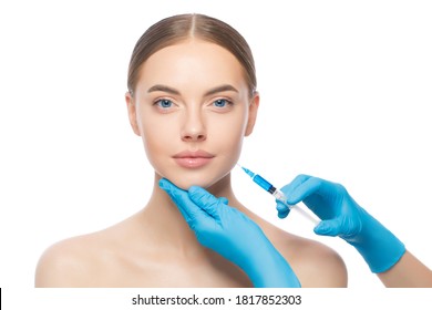 Young woman in beauty clinic, ready for filler injection into cheek to keep skin smooth and young, isolated on white background