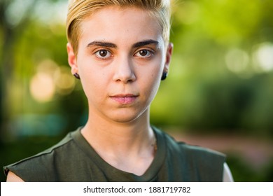 Young woman beauty Tomboy lifestyle with blonde short hair posing in casual clothes in a park in Spain.
Jeans and t-shirt showing armes, gender education and non binary teen. - Shutterstock ID 1881719782