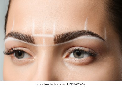 Young woman before procedure of eyebrows permanent makeup, closeup