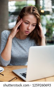 a young woman behind her laptop - Shutterstock ID 1259260693