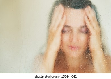 Young Woman Behind Weeping Glass Shower Door