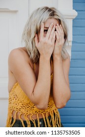 Young Woman Being Embarrased With Her Hands Over Face