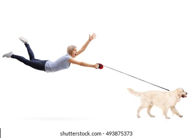 Young woman being pulled by her dog isolated on white background