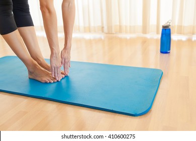 Young Woman Bending Down To Touch Her Toes