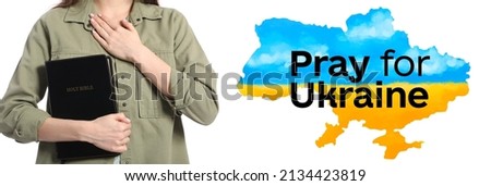 Young woman with Bible and text PRAY FOR UKRAINE on white background