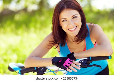 Young Woman With A Bike In A Summer Park. Active People Outdoors. Sport Lifestyle