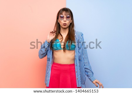 Young woman in bikini with surprise and shocked facial expression