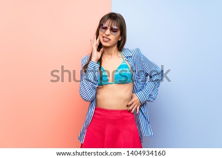 Young woman in bikini with toothache