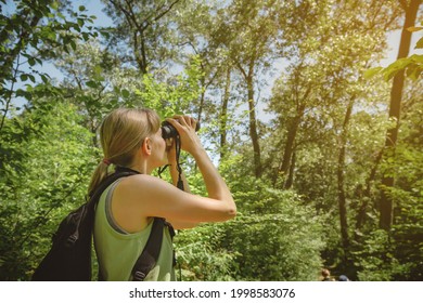 Young Woman Bird Watching With Binoculars At Indiana Dunes State Park.