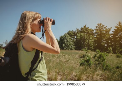 Young Woman Bird Watching With Binoculars At Indiana Dunes State Park.