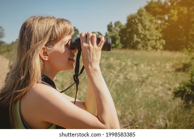 Young Woman Bird Watching With Binoculars At Indiana Dunes State Park.