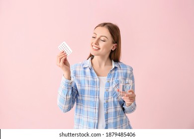 Young Woman With Birth Control Pills On Color Background