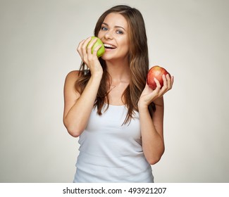 Young woman bites apple. isolated portrait.