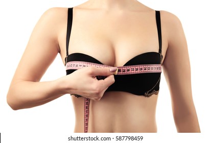 Young woman in black bra with measuring tape on white background, closeup