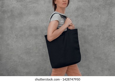 Young Woman With Black Cotton Bag In Her Hands. Mock Up.