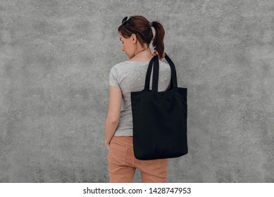 Young Woman With Black Cotton Bag In Her Hands. Mock Up.