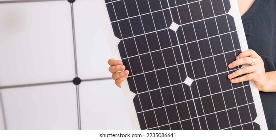 young woman in black dress holding a flexible solar panel - Powered by Shutterstock