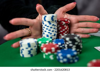 Young Woman In A Black Dress Wins A Game Of Blackjack And Is Happy With All The Chips After Playing Poker. Gambling Concept. All In