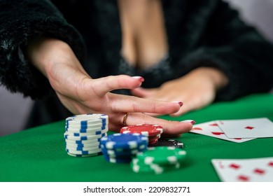 Young Woman In A Black Dress Wins A Game Of Blackjack And Is Happy With All The Chips After Playing Poker. Gambling Concept. All In