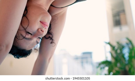 Young Woman With Black Hair In Leggins Doing Yoga Excersices Looking Down Dog At Home In Loft Studio Available Sun Light