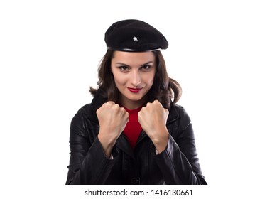 Young woman black jacket, red sweater and hat with a reference to revolutionary looking in camera, demonstrate her fists and smile on a white background with copy space