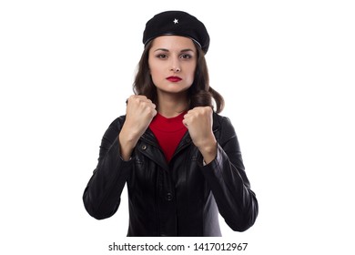 Young woman black jacket, red sweater and hat with a reference to revolutionary looking in camera, demonstrate her fists on a white backgroun