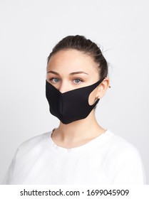 Young Woman With Black Medical Mask Against Corona Virus