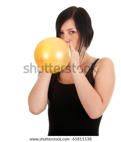 young woman in black shirt  inflating yellow balloon