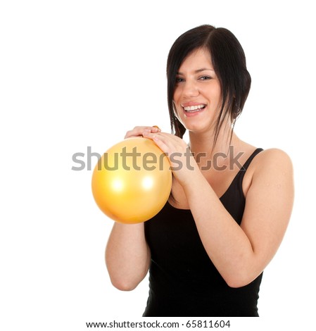 young woman in black shirt  inflating yellow balloon