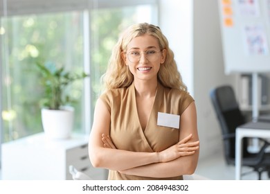 Young Woman With Blank Badge In Office