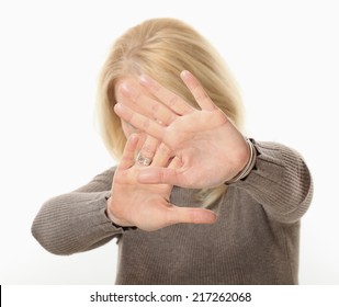 Young Woman Blocking Face With Hands.