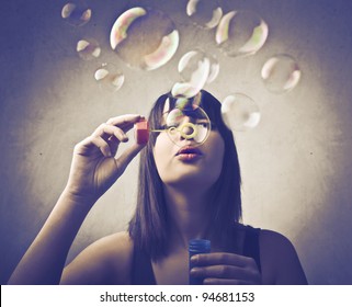 Young Woman Blowing Bubbles