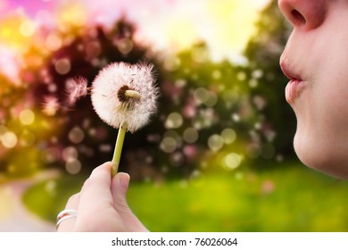 Young Woman Blowing Dandelion