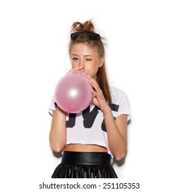 Girls Blowing Balloons