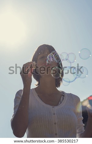 Similar – Young teenage girl blowing pink bubble gum