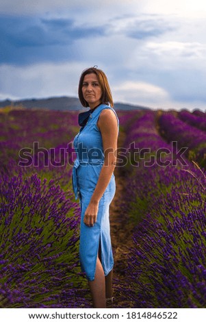 young woman in blue dress in lilac lavender fields