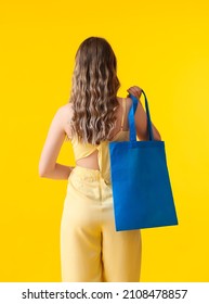 Young Woman With Blue Eco Bag On Yellow Background