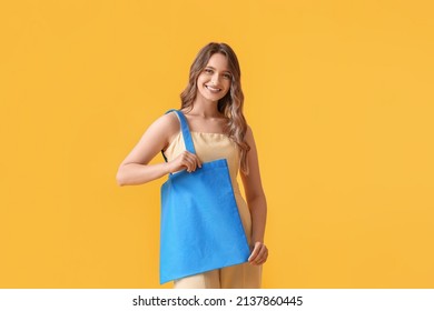 Young Woman With Blue Eco Bag On Yellow Background