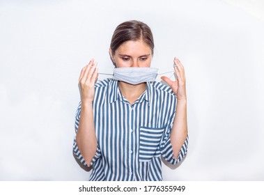 young woman in a blue striped shirt in a medical mask. remedy for coronavirus, pandemic, covid 19, pneumonia.  - Shutterstock ID 1776355949