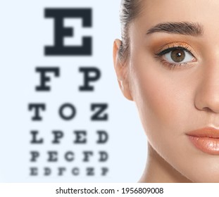 Young Woman And Blurred Eye Chart On Background. Visiting Ophthalmologist 