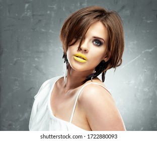 Young Woman With Bob Haircut And Yellow Lips, Strong Make Up. Woman With Short Hair.