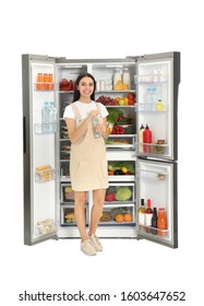 Young Woman With Bottle Of Water Near Open Refrigerator On White Background