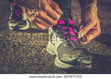 Young woman bound shoes on the track for practice