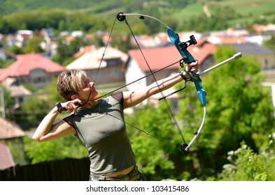 young woman with a bow and arrows in the woods - Shutterstock ID 103415486