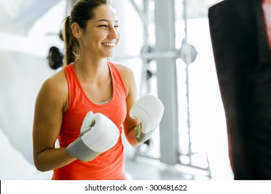 Young woman boxing and training in a gym - Powered by Shutterstock