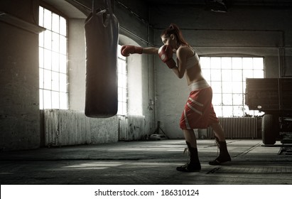Young Woman Boxing Workout In An Old Building