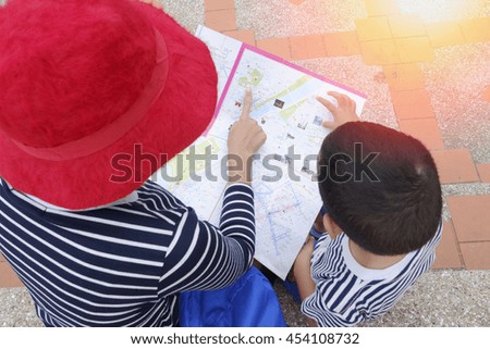 Similar – Image, Stock Photo boy with hat and map on blue background