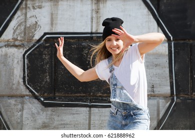 Young Woman Break Dancing On Wall Background.  Hip-Hop Dancer.