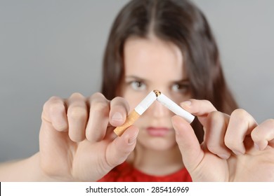 Young Woman Breaking Cigarette